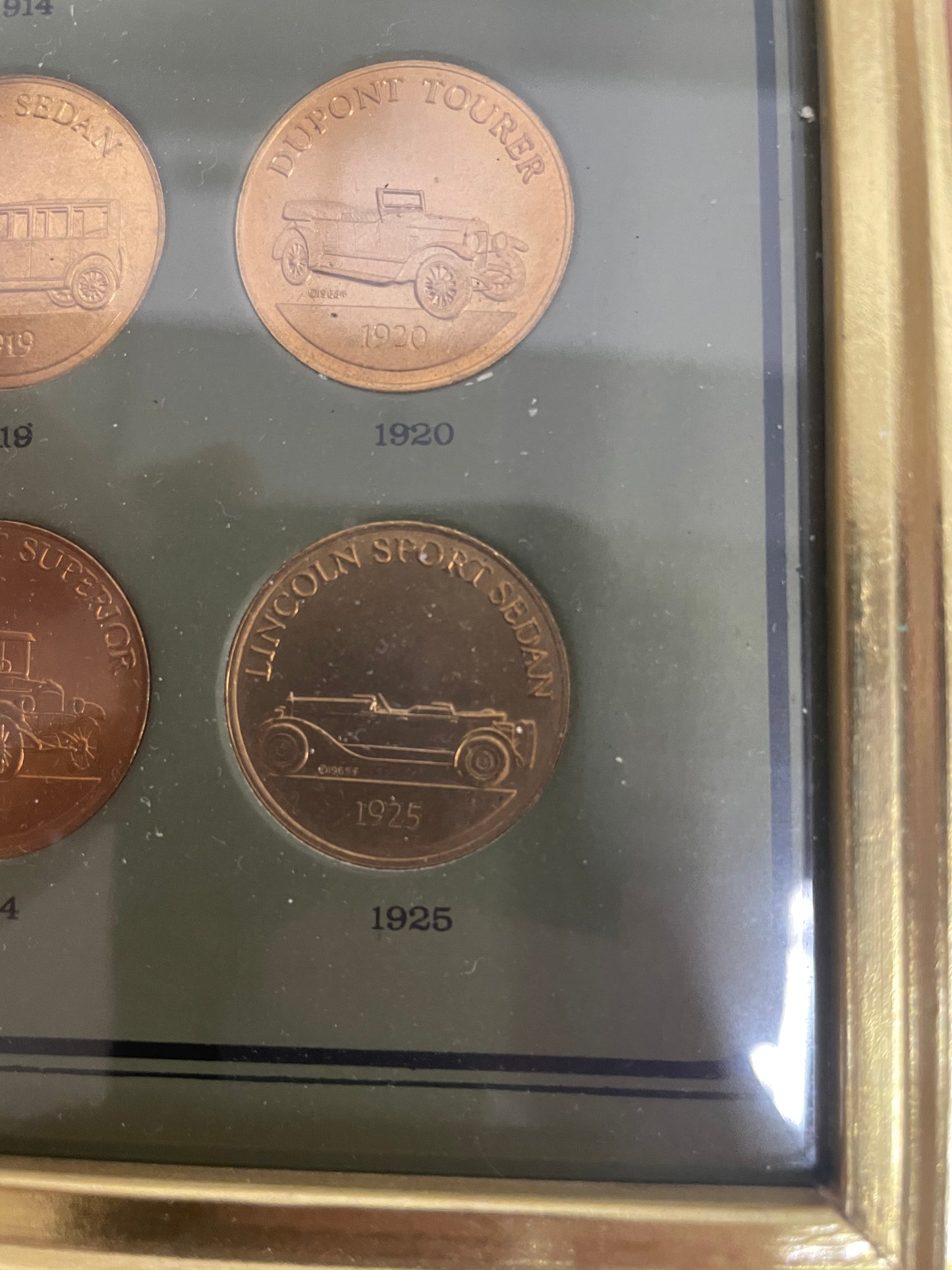 The Franklin Mint Antique Car Coin Collection 10x12in. 1901-1925. Wooden frame included.