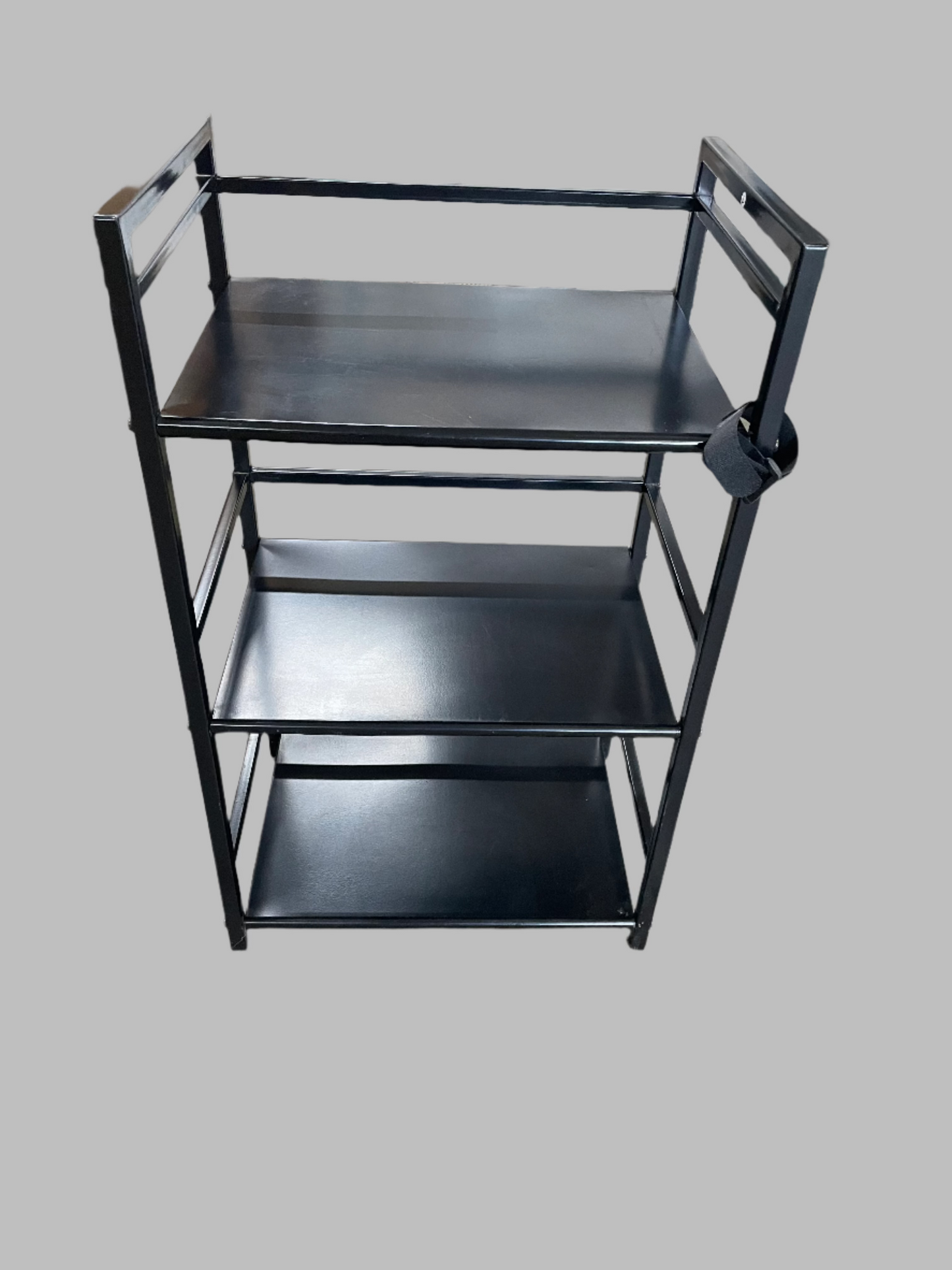 Black Multipurpose Shelf. Metal. 3 shelves. 28inches tall, 17in wide, 11.5in long.