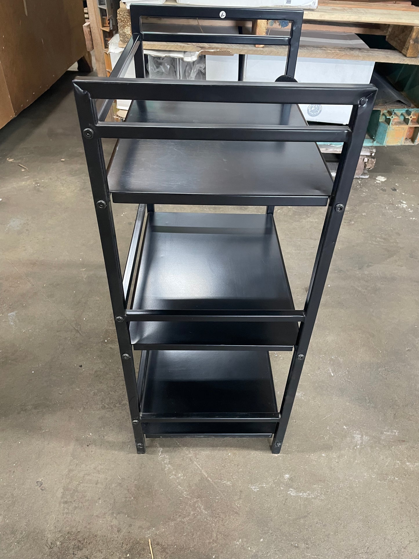 Black Multipurpose Shelf. Metal. 3 shelves. 28inches tall, 17in wide, 11.5in long.