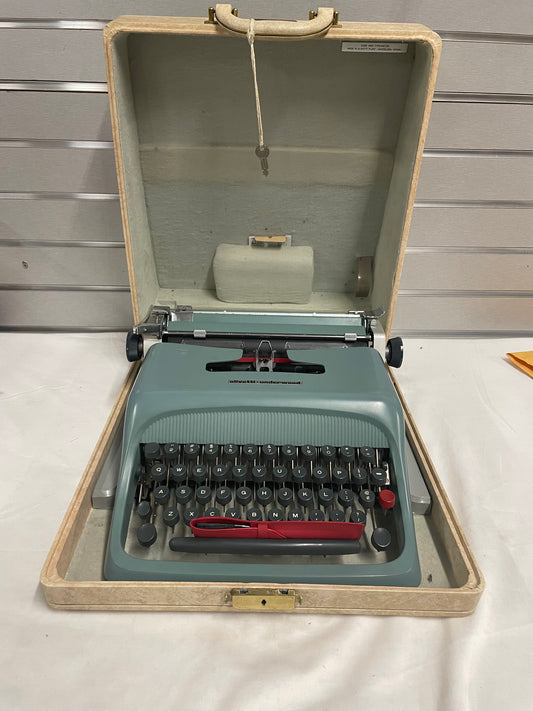 Blue Olivetti Underwood Typewriter. With lockable case. No electric. Comes with paper and brush.