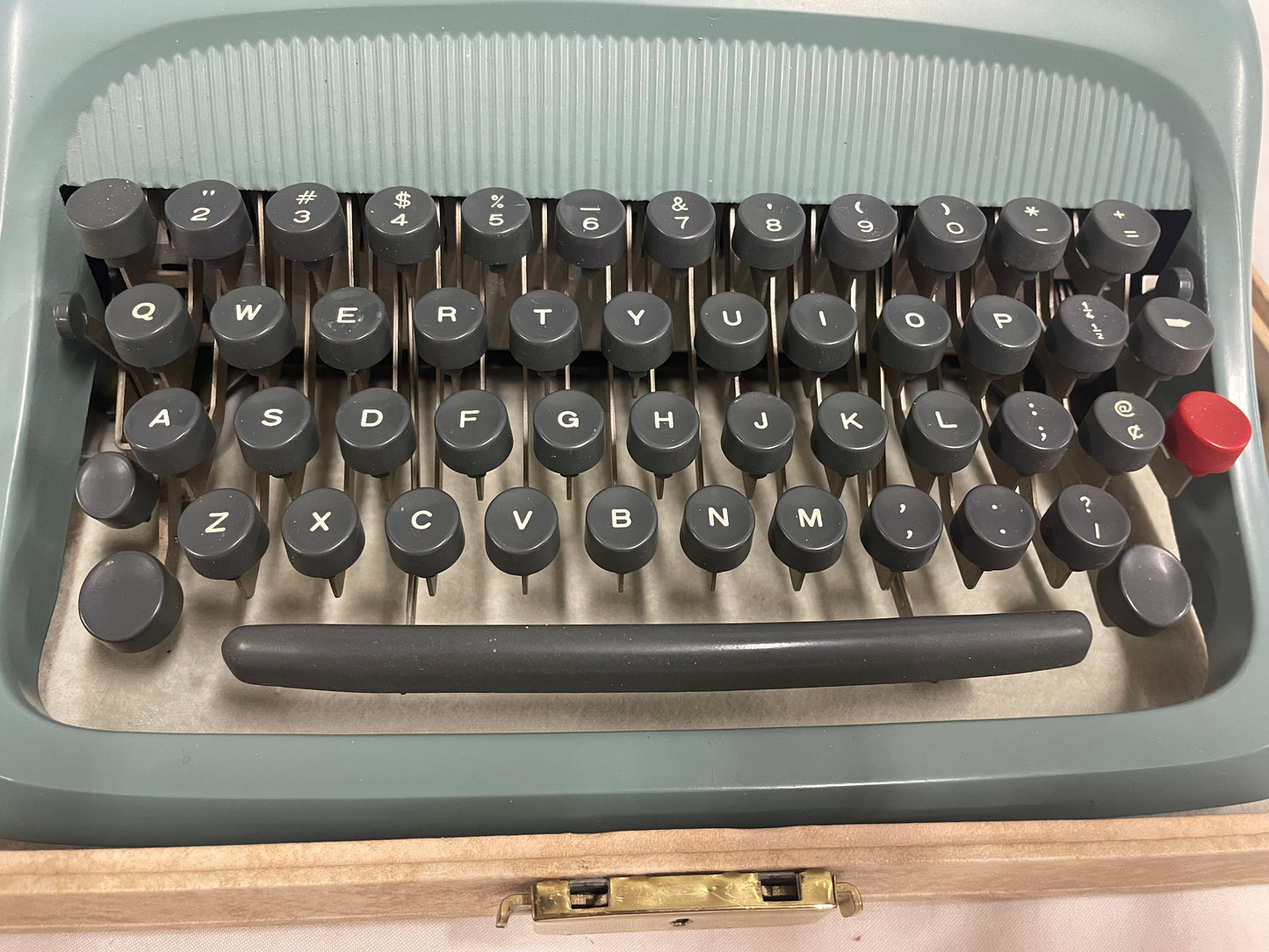 Blue Olivetti Underwood Typewriter. With lockable case. No electric. Comes with paper and brush.