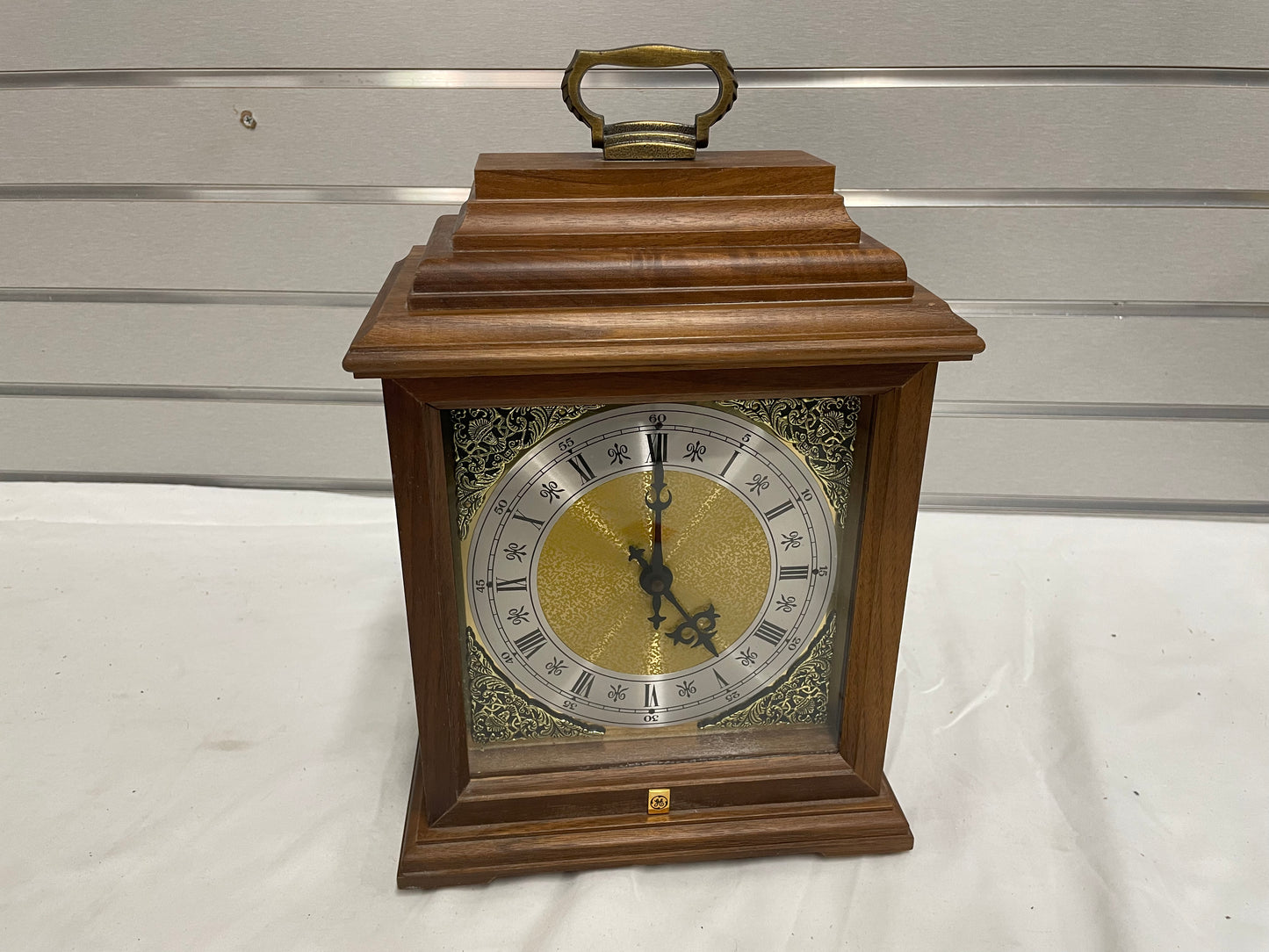 Jostens Decrative GE commemoritive Box Clock. Wooden box. Metal inside. Back opens up. Handle on top.