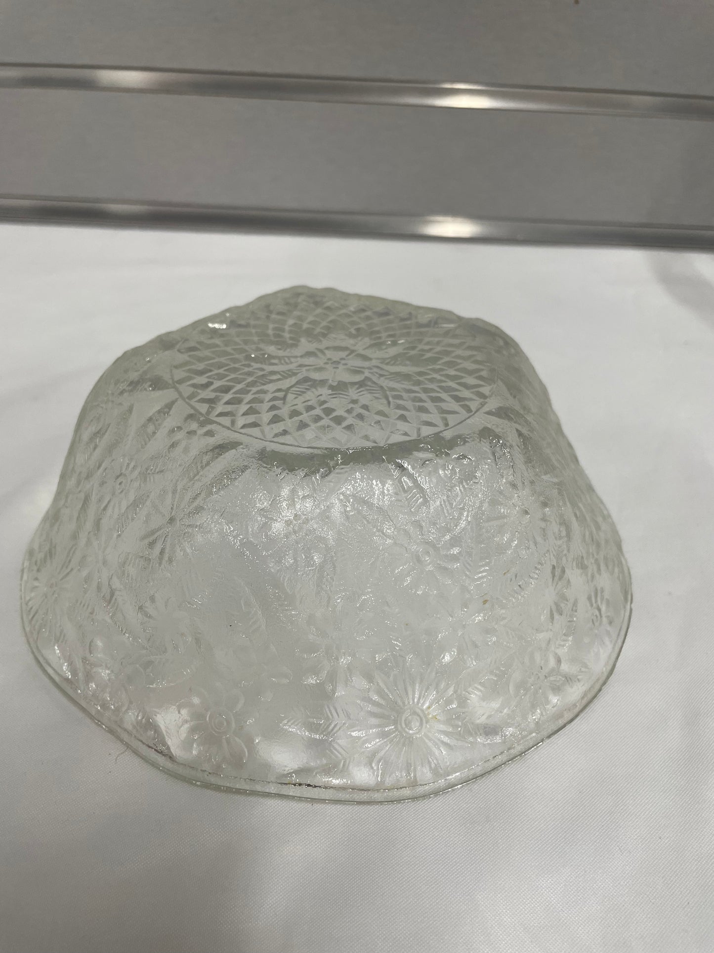 Small Detailed Glass Bowl. 7.5”x2.5”. Flower details.