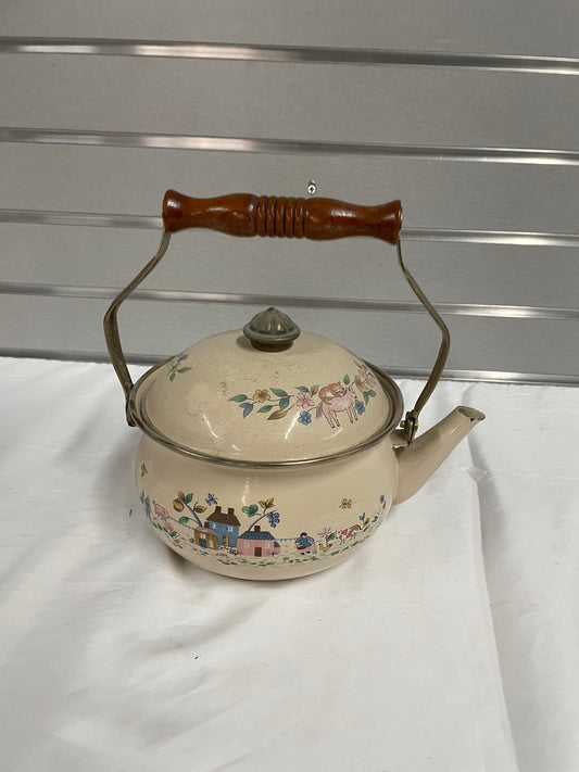 Old vintage ceramic teapot with wooden handle. Hand painted farm scene on the sides. Teapot is a peach color and has no damage to it