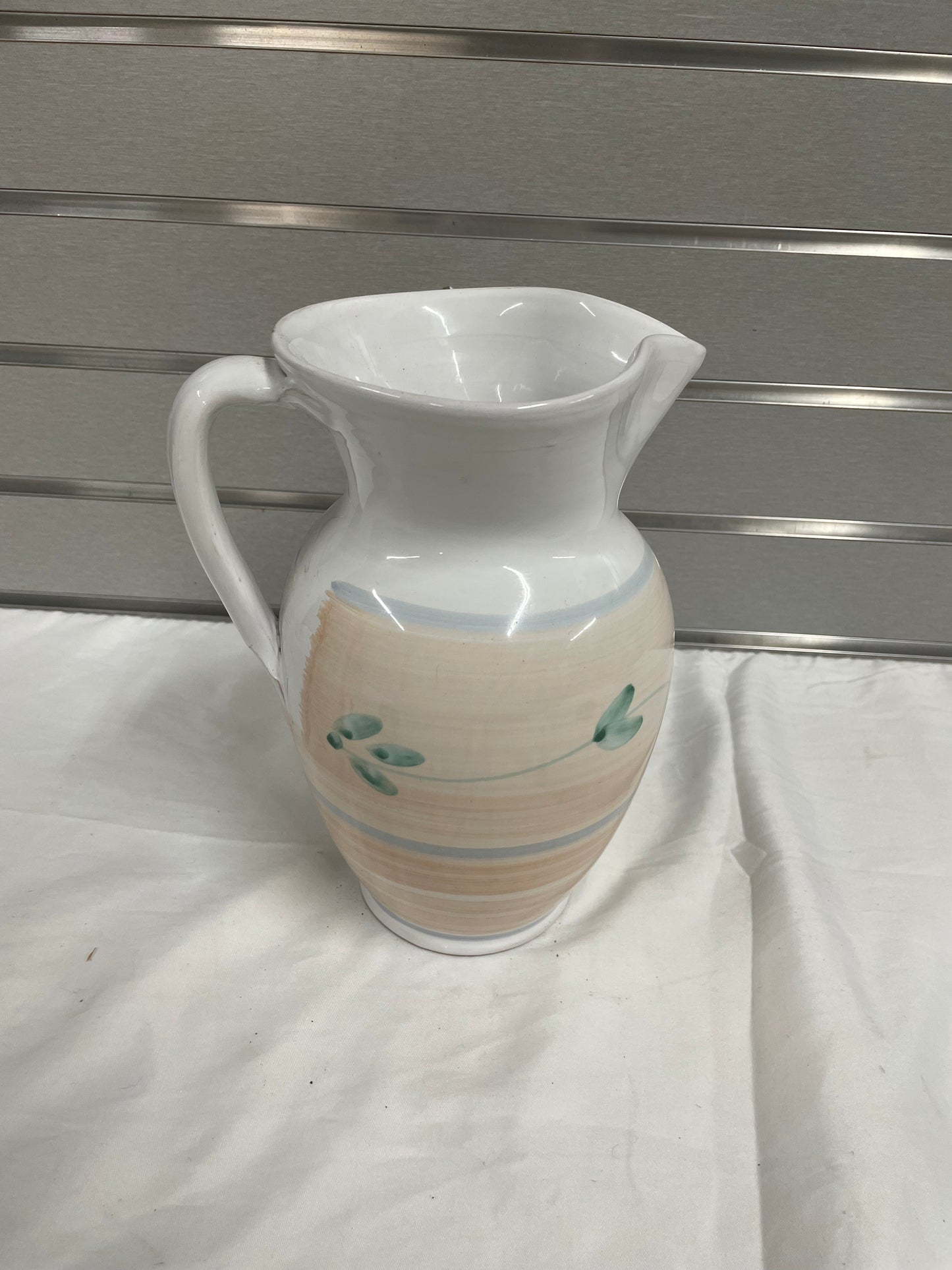 Old White Ceramic Pitcher. Pitcher is hand painted with flowers on sides