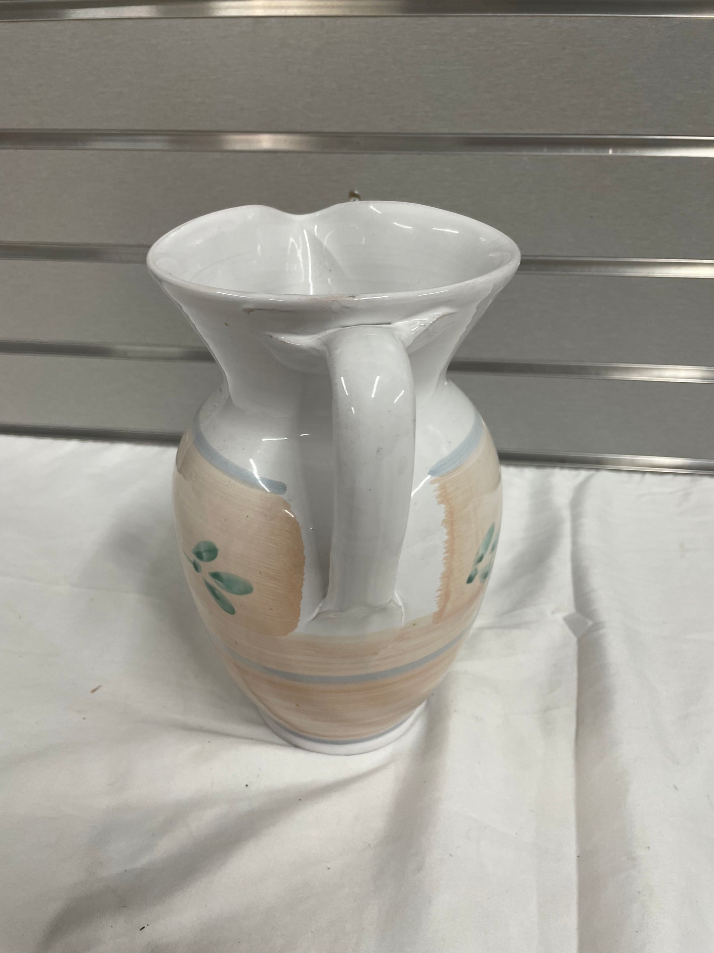 Old White Ceramic Pitcher. Pitcher is hand painted with flowers on sides