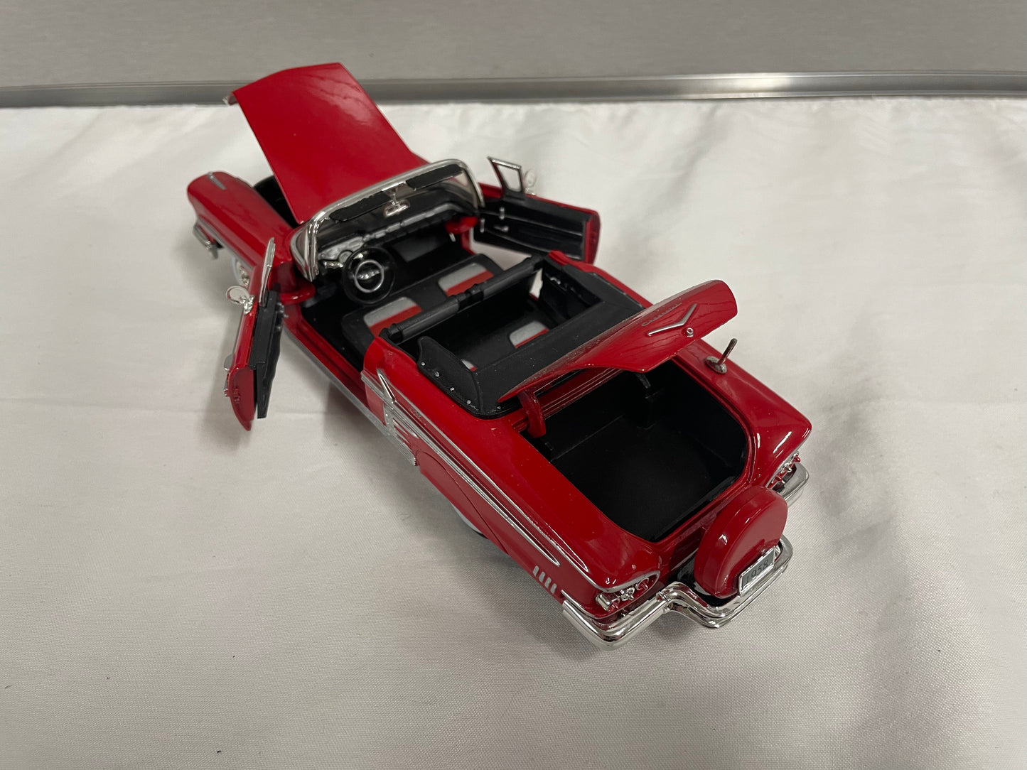 1958 Chevrolet Impala Diecast Model Car. 1:25 Scale car. Metal car. Impala is red and a convertible