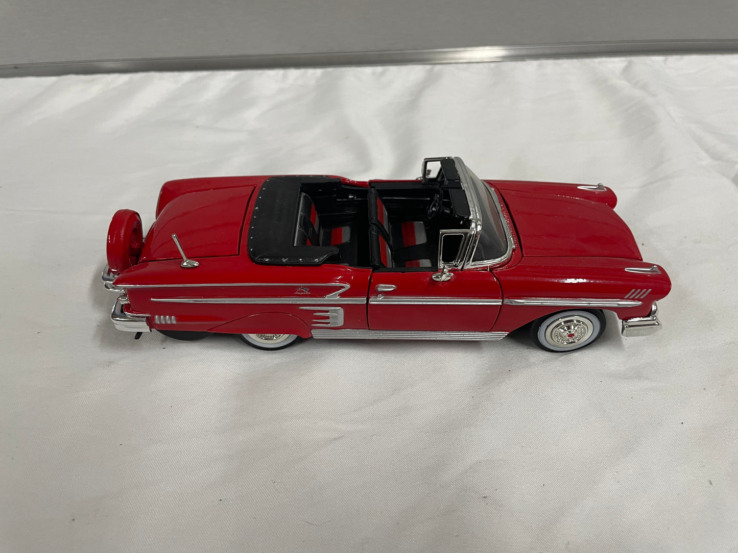 1958 Chevrolet Impala Diecast Model Car. 1:25 Scale car. Metal car. Impala is red and a convertible