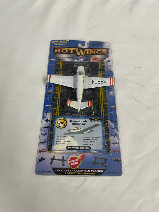 Hot Wings Beechcraft Bonanza Die Cast Collectible Plane. 2001 Collectors edition. 4 inches long. White plane. In original box.